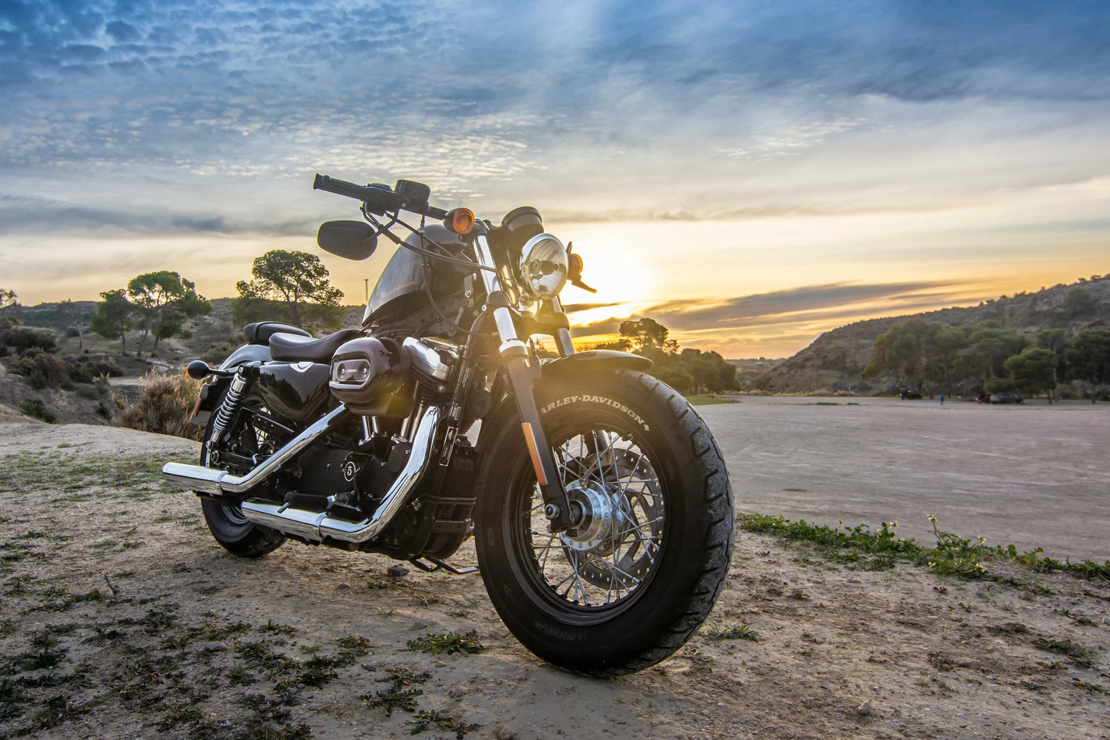 Mechanic servicing a motorcycle outdoors